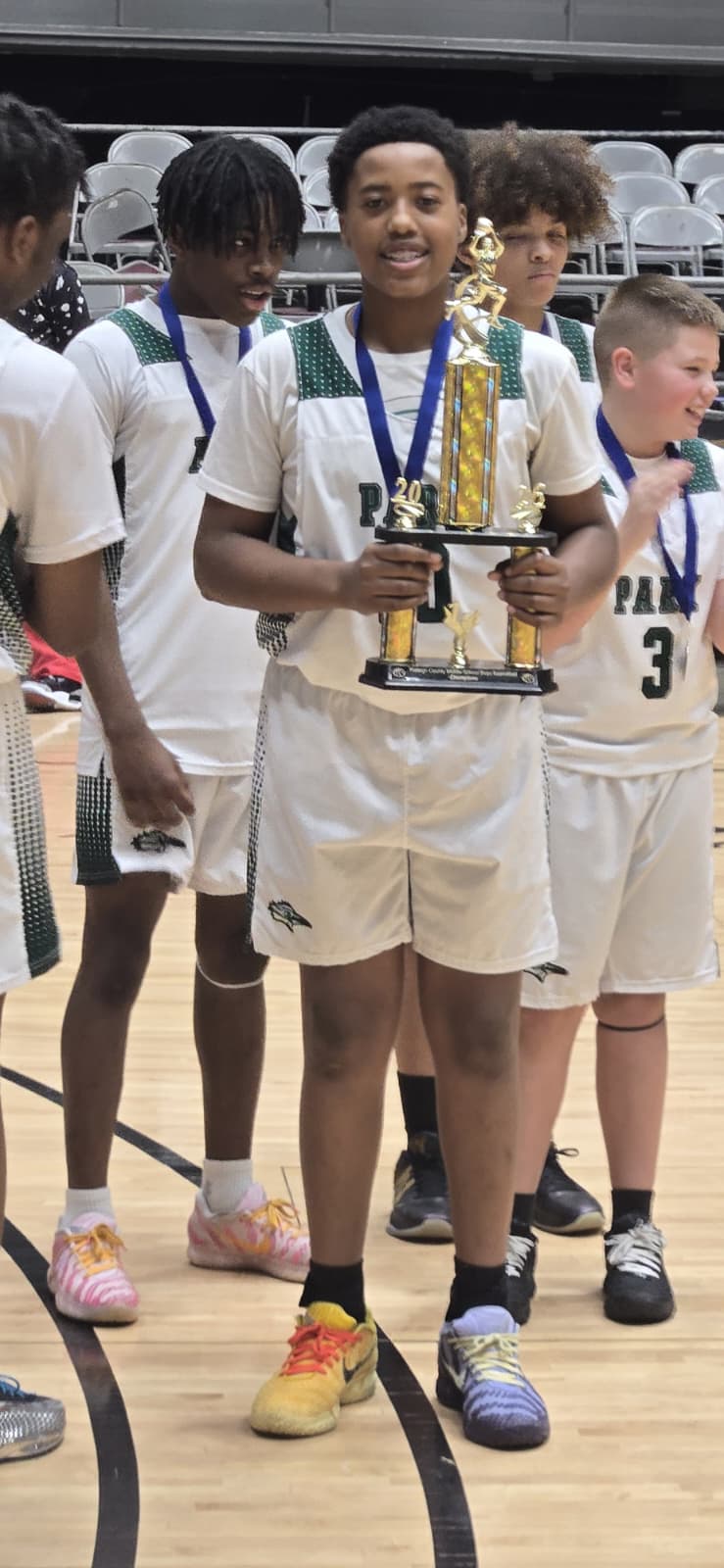 Ross holding basketball championship trophy